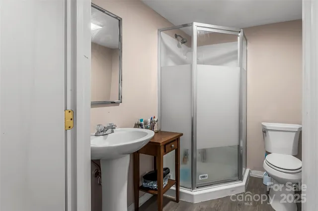 a bathroom with a sink toilet and shower