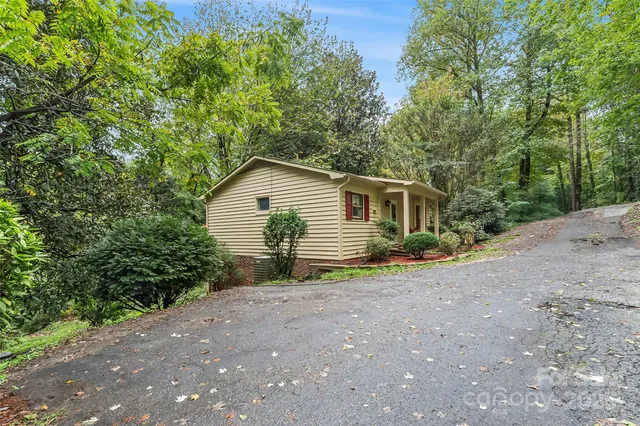 a view of an house with backyard space and garden