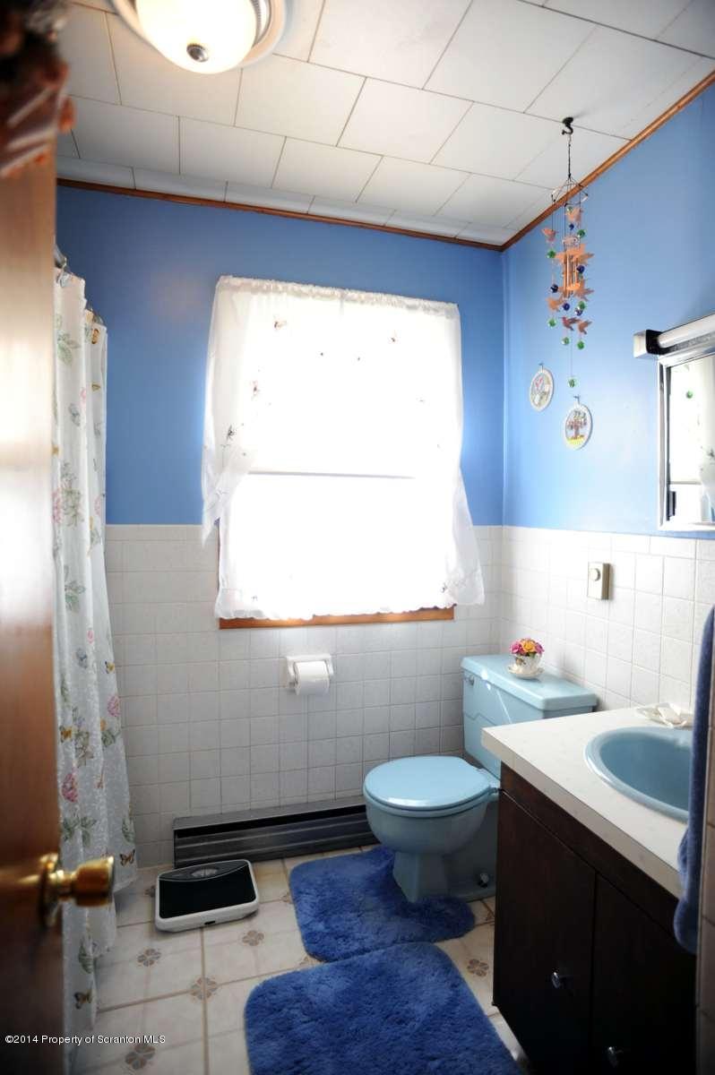 365 State Rte 2035 Nicholson, PA 18446 - Photo 20 of 28 a bathroom with a sink a toilet and a window