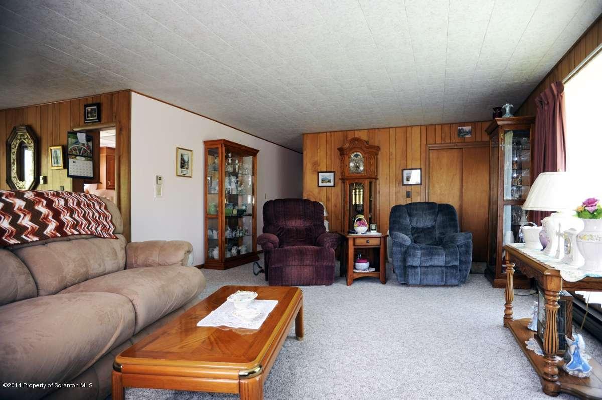 365 State Rte 2035 Nicholson, PA 18446 - Photo 2 of 28 a living room with furniture and a lamp