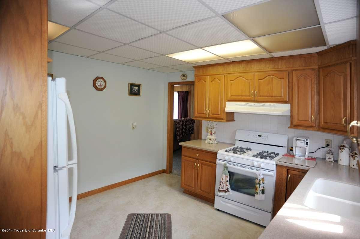 365 State Rte 2035 Nicholson, PA 18446 - Photo 6 of 28 a kitchen with a stove top oven sink and cabinets