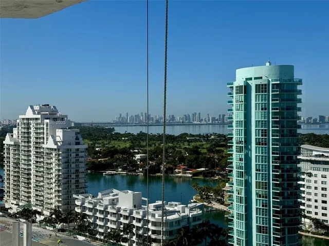 a view of ocean with tall buildings