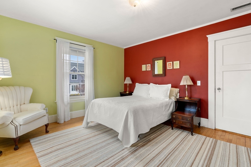347 Manning Street Needham, MA 02492 - Photo 29 of 42 a bedroom with a bed and wooden floor