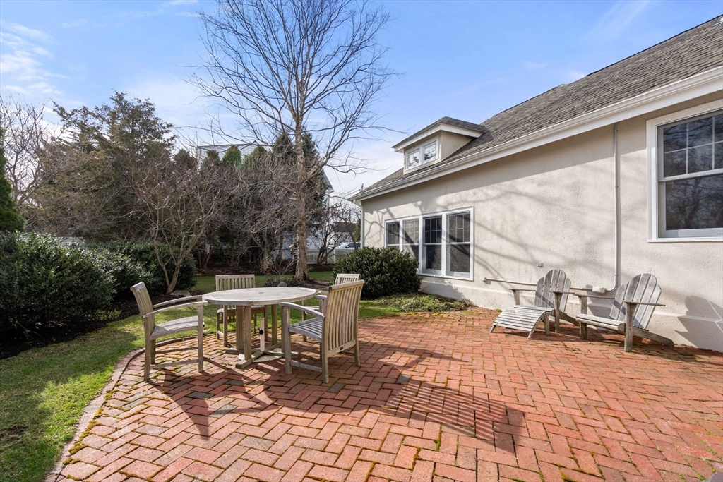 347 Manning Street Needham, MA 02492 - Photo 38 of 42 a view of a patio with a table chairs and a bench