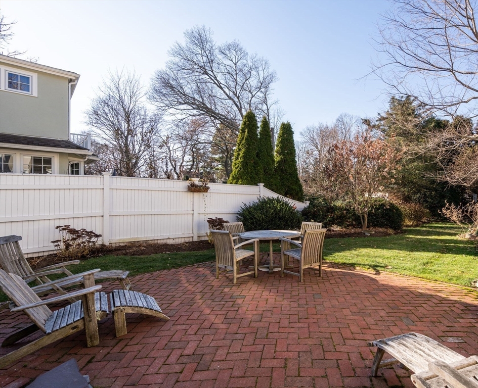 347 Manning Street Needham, MA 02492 - Photo 39 of 42 a view of a backyard with chairs potted plants and a bench