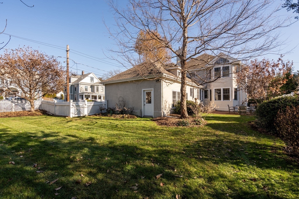 347 Manning Street Needham, MA 02492 - Photo 40 of 42 a backyard of a house with fountain plants and large tree