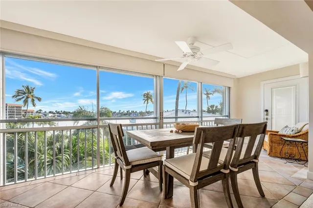 a dining room with furniture a chandelier and garden view