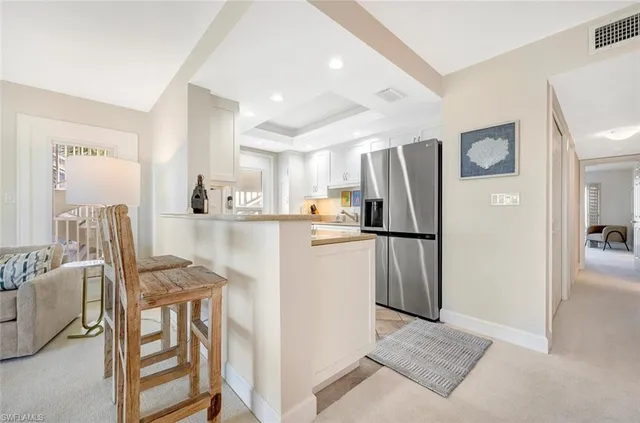 a kitchen with stainless steel appliances granite countertop a refrigerator and a stove top oven