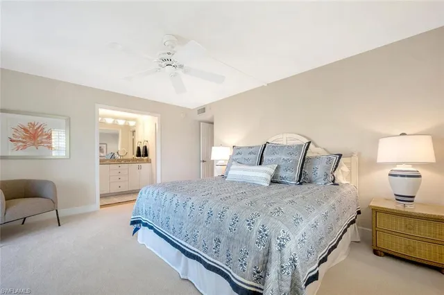 a bedroom with a bed and a lamp