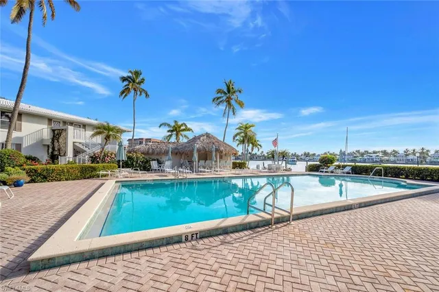 a view of swimming pool with outdoor seating and plants