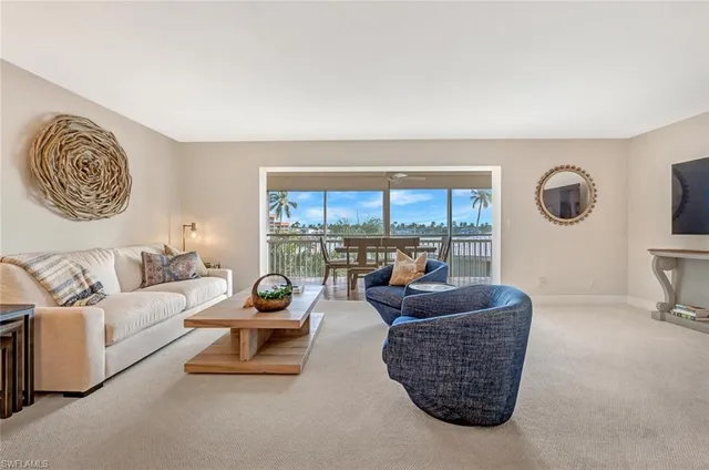a living room with furniture and a floor to ceiling window