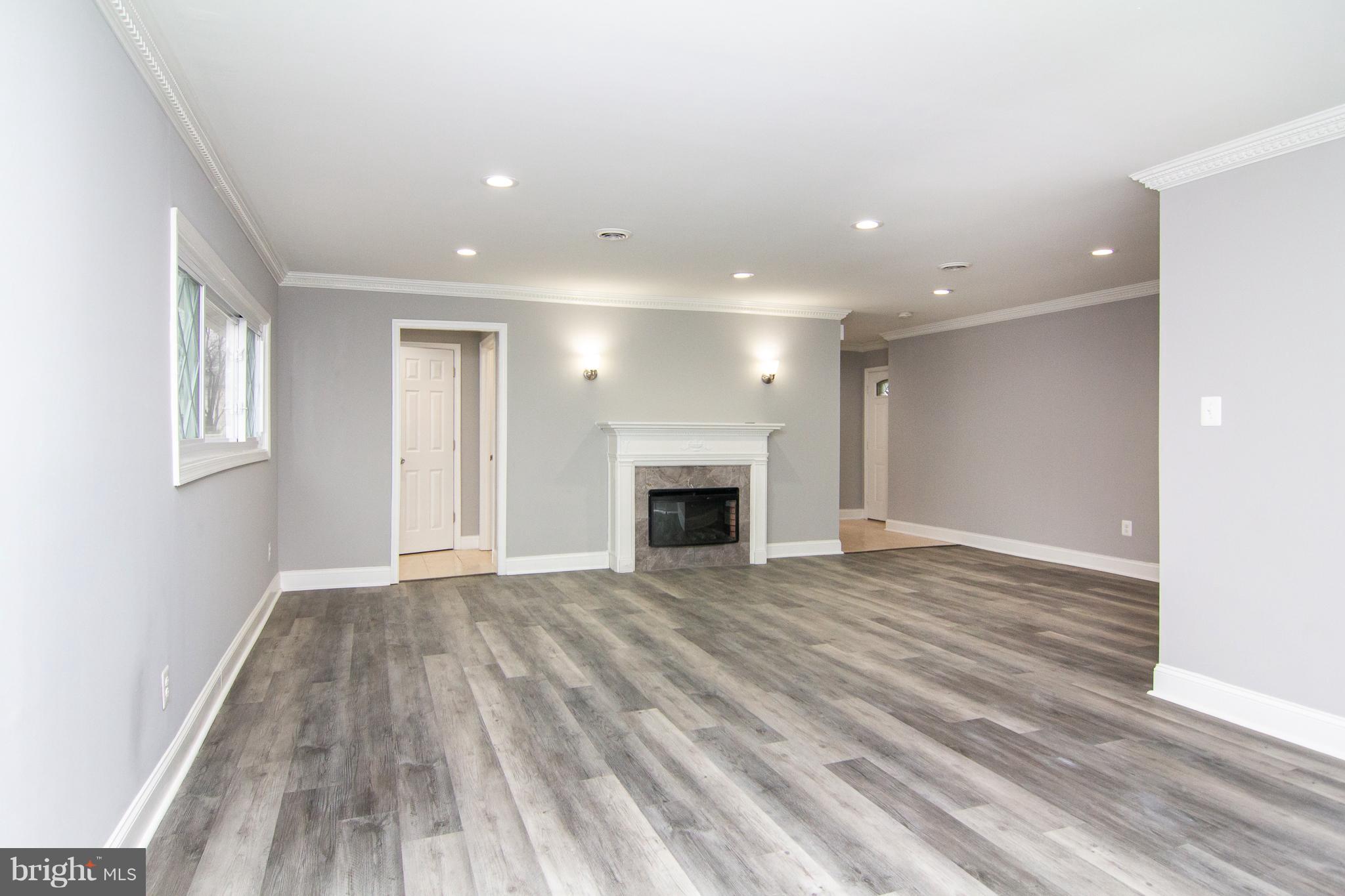 1934 Winder Road Windsor Mill, MD 21244 - Photo 13 of 31 an empty room with wooden floor and fireplace