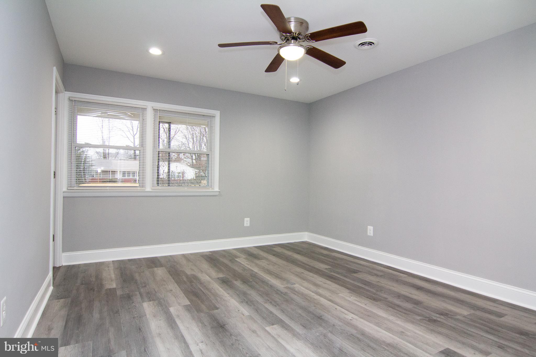 1934 Winder Road Windsor Mill, MD 21244 - Photo 21 of 31 an empty room with wooden floor and windows
