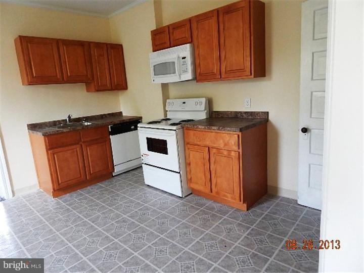 14 West Park Road Havertown, PA 19083 - Photo 6 of 15 a kitchen with stainless steel appliances granite countertop a stove a sink and a microwave