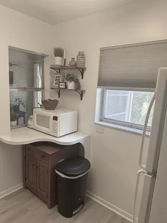 a living room with a floor to ceiling window and a table
