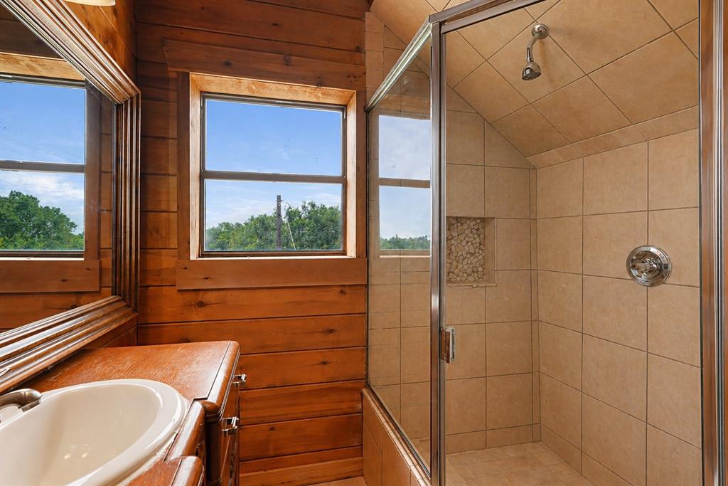 371 Spring Street Forestburg, TX 76239 - Photo 25 of 38 a bathroom with a sink a toilet and shower