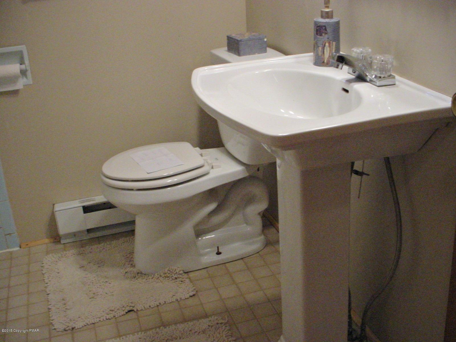 164 Buckhill Road Albrightsville, PA 18210 - Photo 10 of 21 a bathroom with a sink a toilet and a mirror