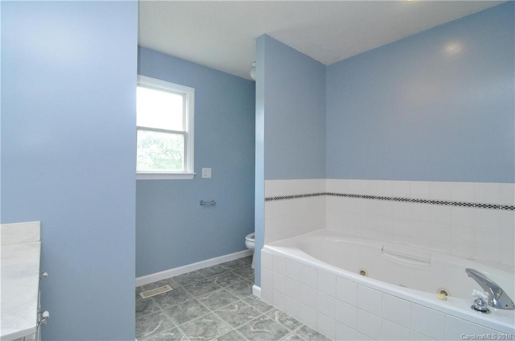 1200 Macedonia Church Road Campobello, SC 29322 - Photo 19 of 26 a white bath tub sitting in a bathroom