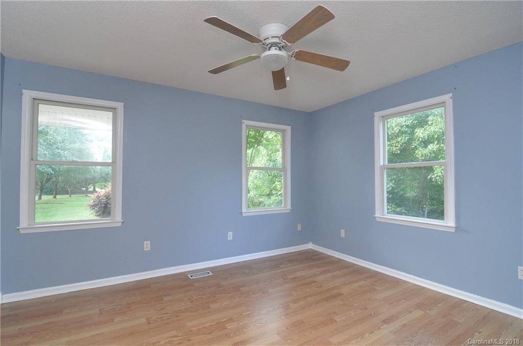 1200 Macedonia Church Road Campobello, SC 29322 - Photo 20 of 26 a view of an empty room with a window and a ceiling fan