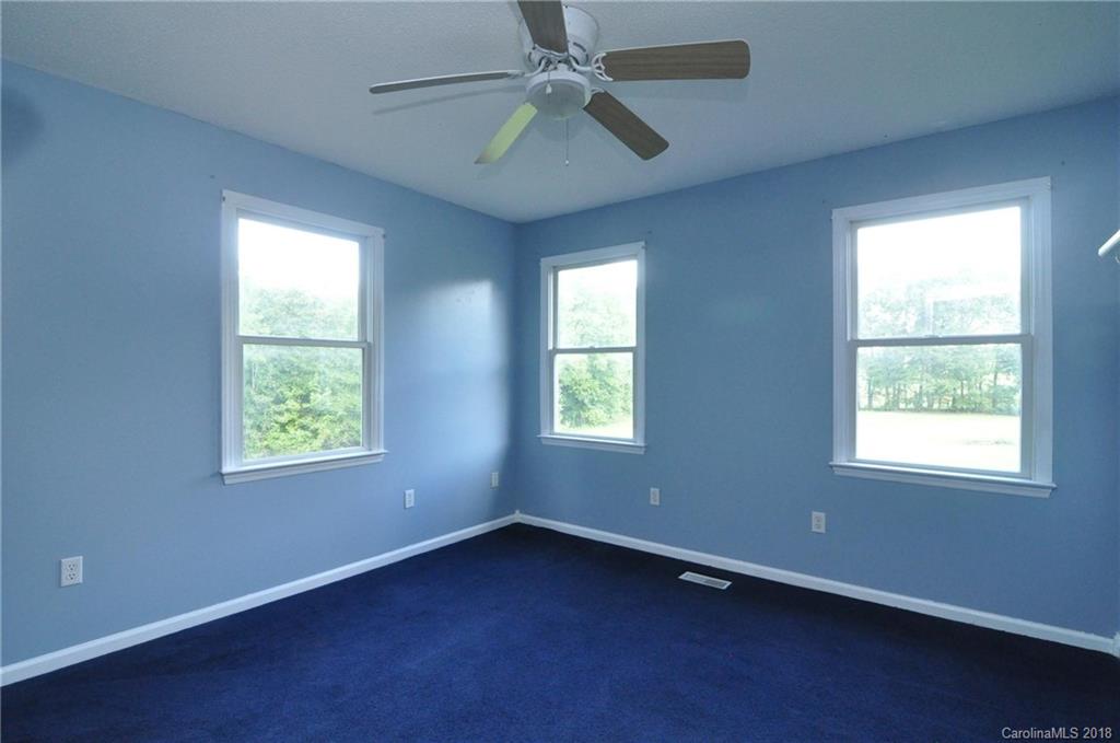 1200 Macedonia Church Road Campobello, SC 29322 - Photo 21 of 26 an empty room with a window and a fan