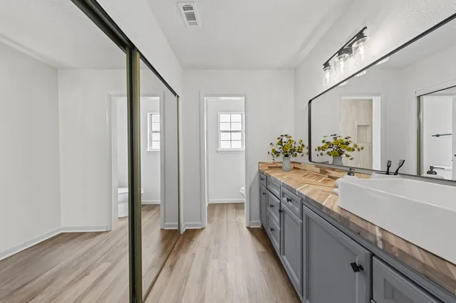 a kitchen with granite countertop a sink and wooden floor