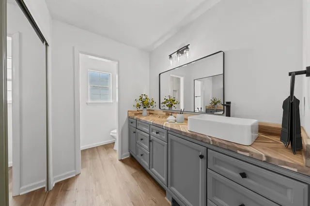 a spacious bathroom with a double vanity sink and a mirror