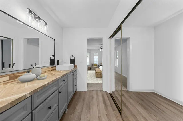 a spacious bathroom with a granite countertop sink mirror and shower