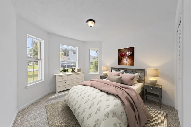 a bed room with a bed and a window