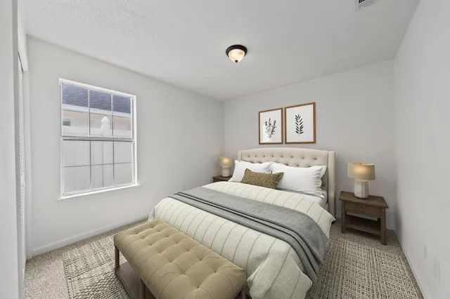 a bedroom with a bed and a window