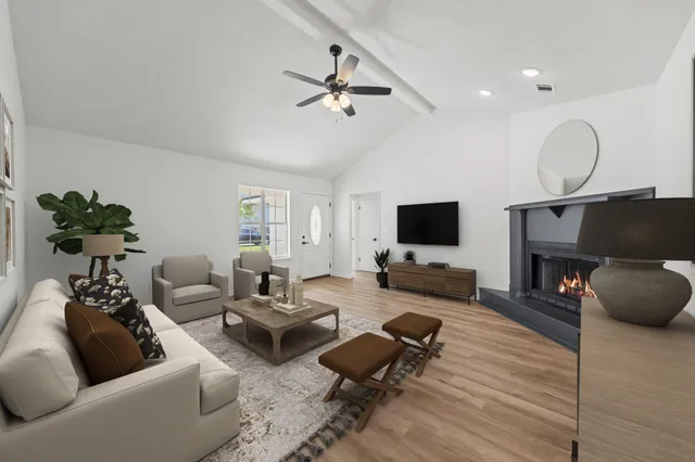 a living room with furniture and a flat screen tv
