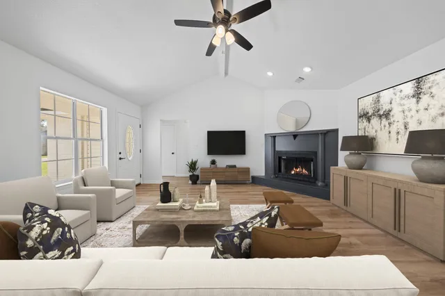 a living room with furniture fireplace and a flat screen tv