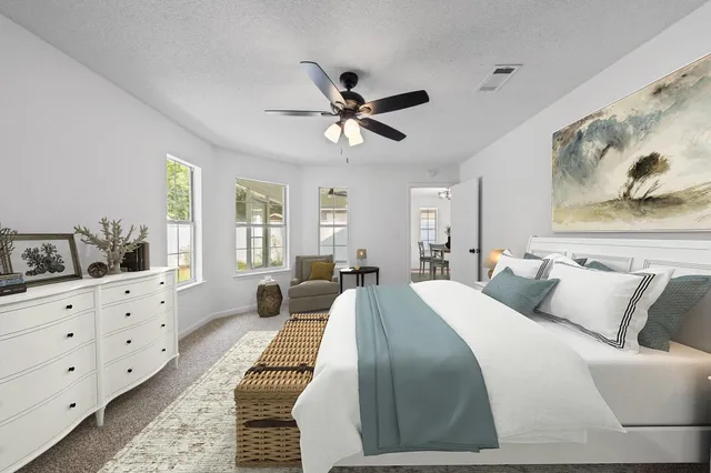 a spacious bedroom with a bed and window