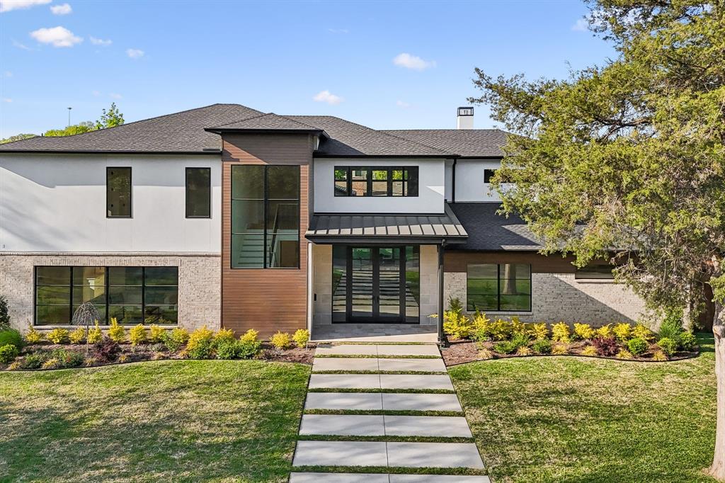 6215 Lafayette Way Dallas, TX 75230 - Photo 2 of 36 a front view of a house with a garden and plants