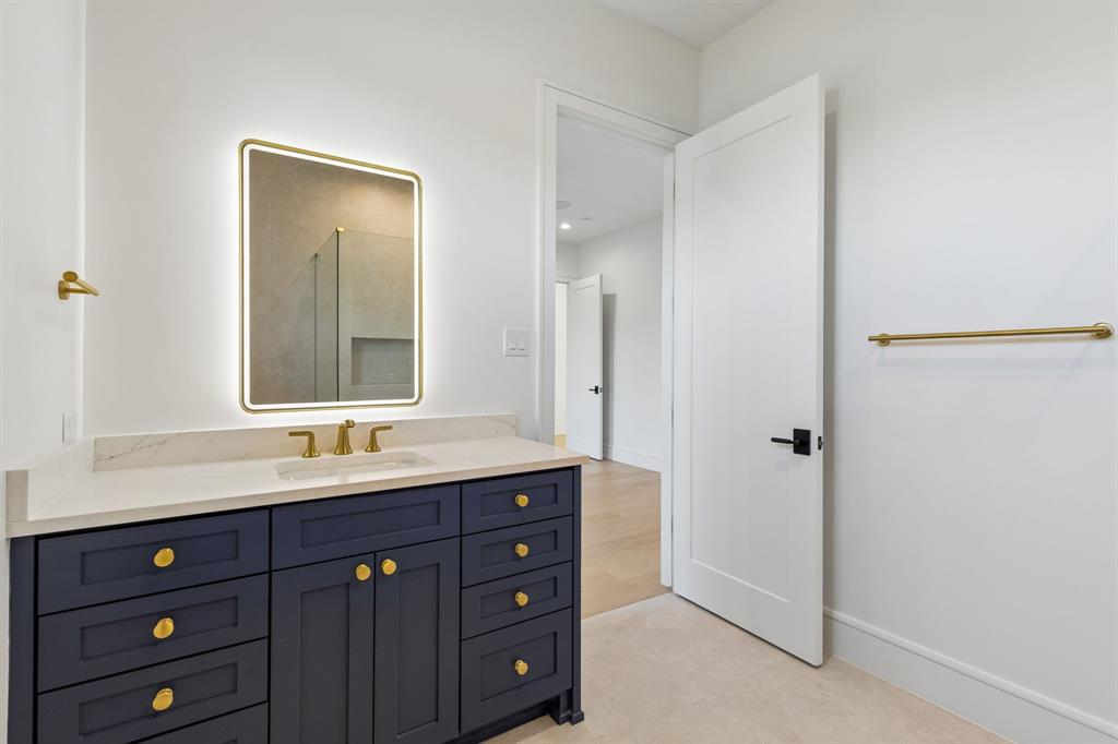 6215 Lafayette Way Dallas, TX 75230 - Photo 30 of 36 a bathroom with a double vanity sink and mirror with shower