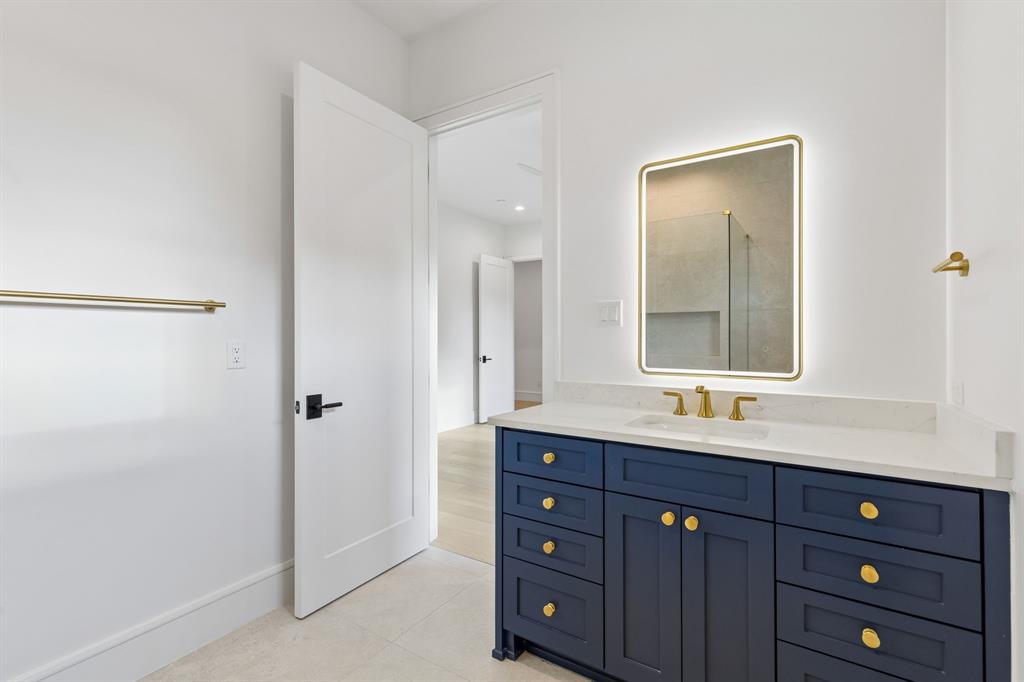 6215 Lafayette Way Dallas, TX 75230 - Photo 32 of 36 a bathroom with a double vanity sink and mirror with shower