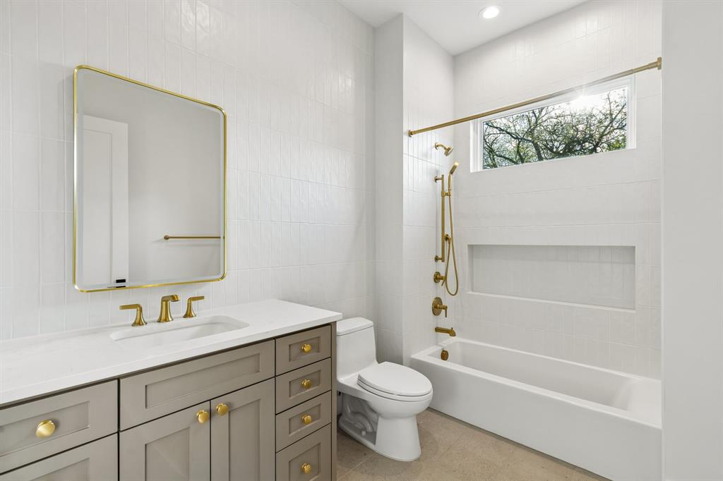 6215 Lafayette Way Dallas, TX 75230 - Photo 33 of 36 a bathroom with a granite countertop sink toilet and shower