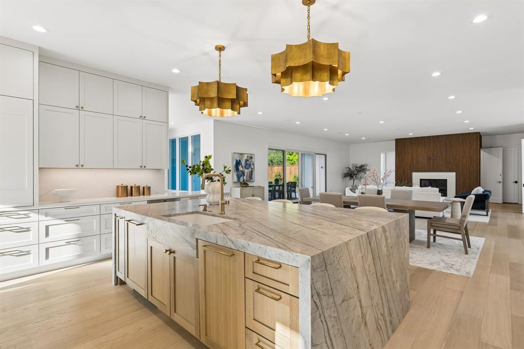 6215 Lafayette Way Dallas, TX 75230 - Photo 9 of 36 a kitchen with kitchen island stainless steel appliances a sink and a stove