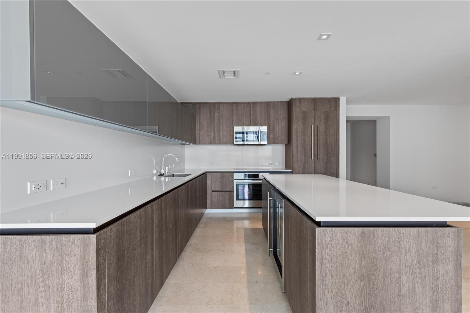 88 Southwest 7th Street, Unit 904 Miami, FL 33130 - Photo 5 of 26 a kitchen with a stove and a refrigerator