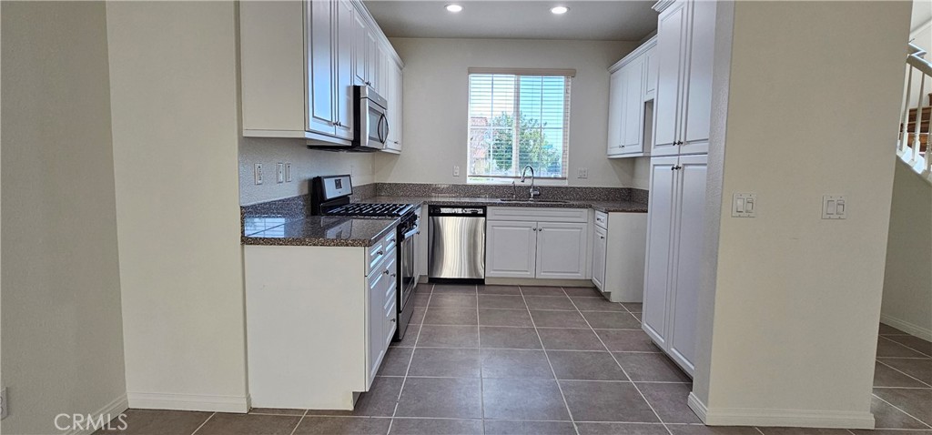 8652 Cava Drive Rancho Cucamonga, CA 91730 - Photo 11 of 44 a kitchen with stainless steel appliances granite countertop a stove a sink and a refrigerator