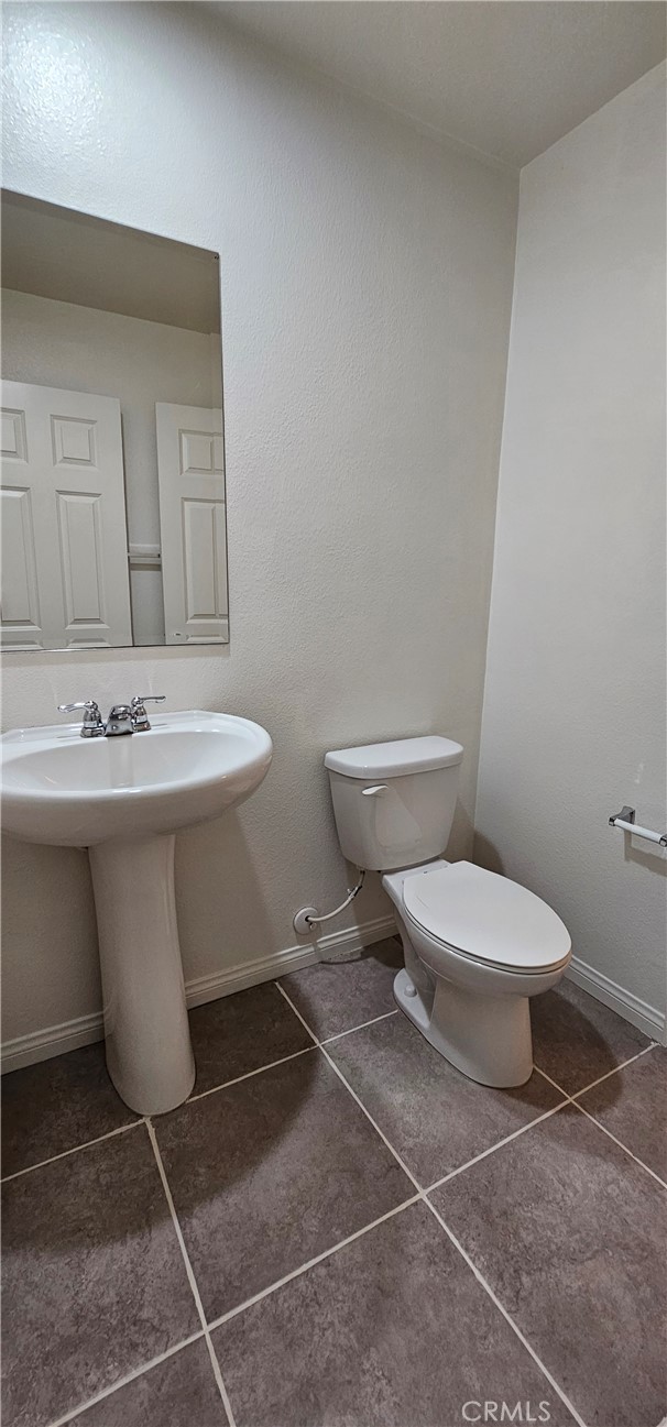 8652 Cava Drive Rancho Cucamonga, CA 91730 - Photo 15 of 44 a white toilet sitting next to a white sink and vanity