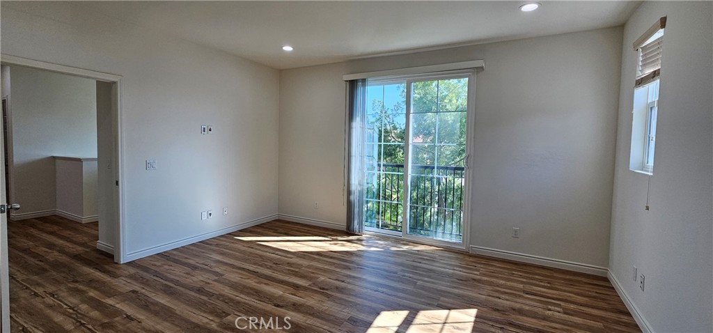 8652 Cava Drive Rancho Cucamonga, CA 91730 - Photo 23 of 44 an empty room with wooden floor and entrance