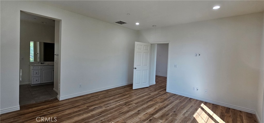 8652 Cava Drive Rancho Cucamonga, CA 91730 - Photo 24 of 44 a view of an empty room with wooden floor and a window