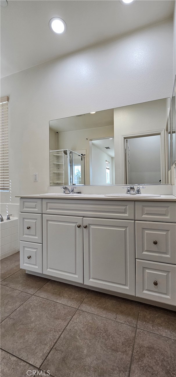 8652 Cava Drive Rancho Cucamonga, CA 91730 - Photo 28 of 44 a bathroom with a granite countertop sink double and mirror