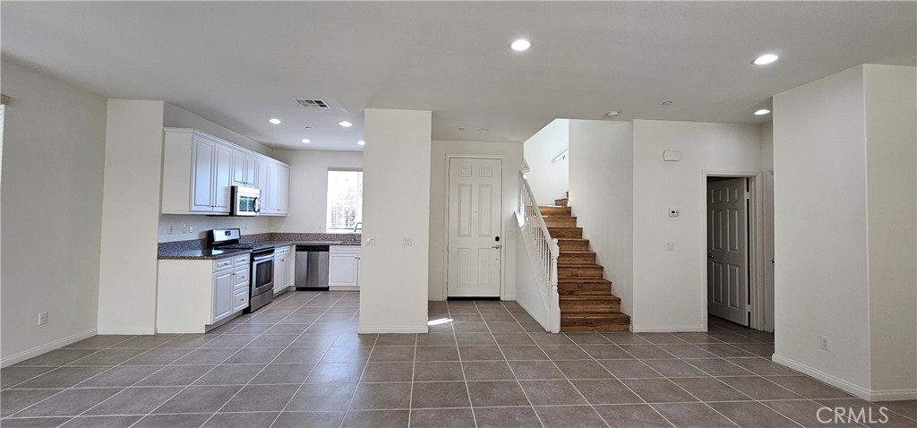 8652 Cava Drive Rancho Cucamonga, CA 91730 - Photo 9 of 44 a view of a kitchen with a sink and a large window