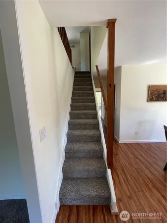 a view of entryway and hall with wooden floor