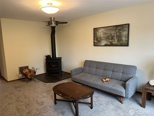 a living room with furniture and a chandelier