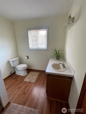 a bathroom with a sink toilet and a mirror
