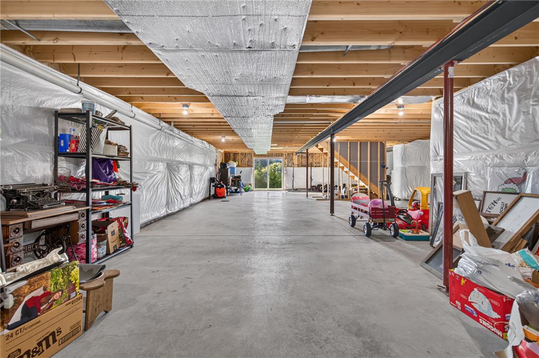 74 Kepners Road New Ringgold, PA 17960 - Photo 68 of 79 An expansive unfinished lower level with concrete flooring and wood ceiling joists opens to the outdoors.