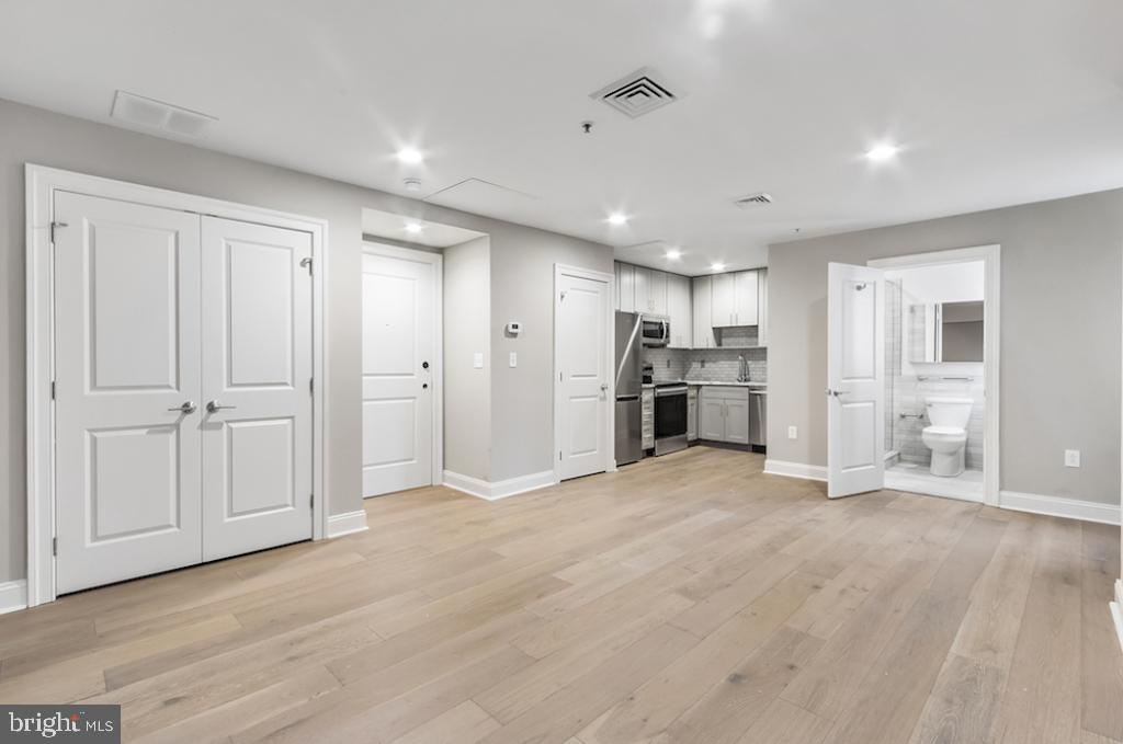 a view of a kitchen with a refrigerator a sink and dishwasher cabinets