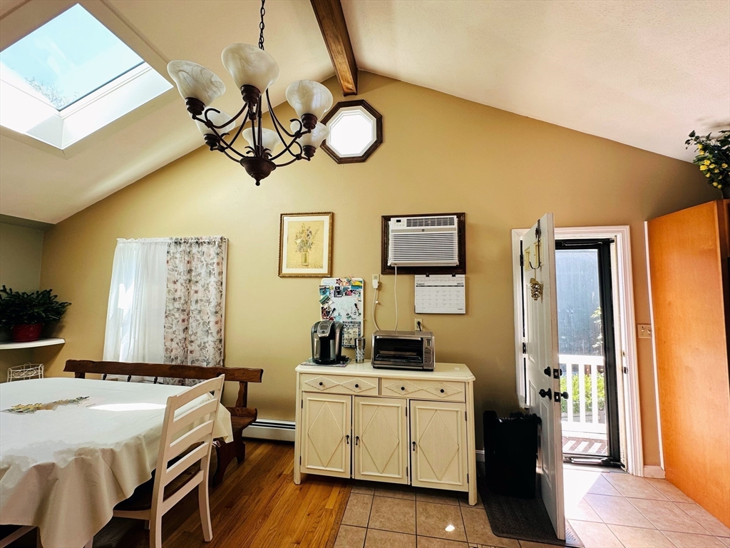 4 Mersea Street Saugus, MA 01906 - Photo 13 of 28 a bedroom with a bed and a chandelier